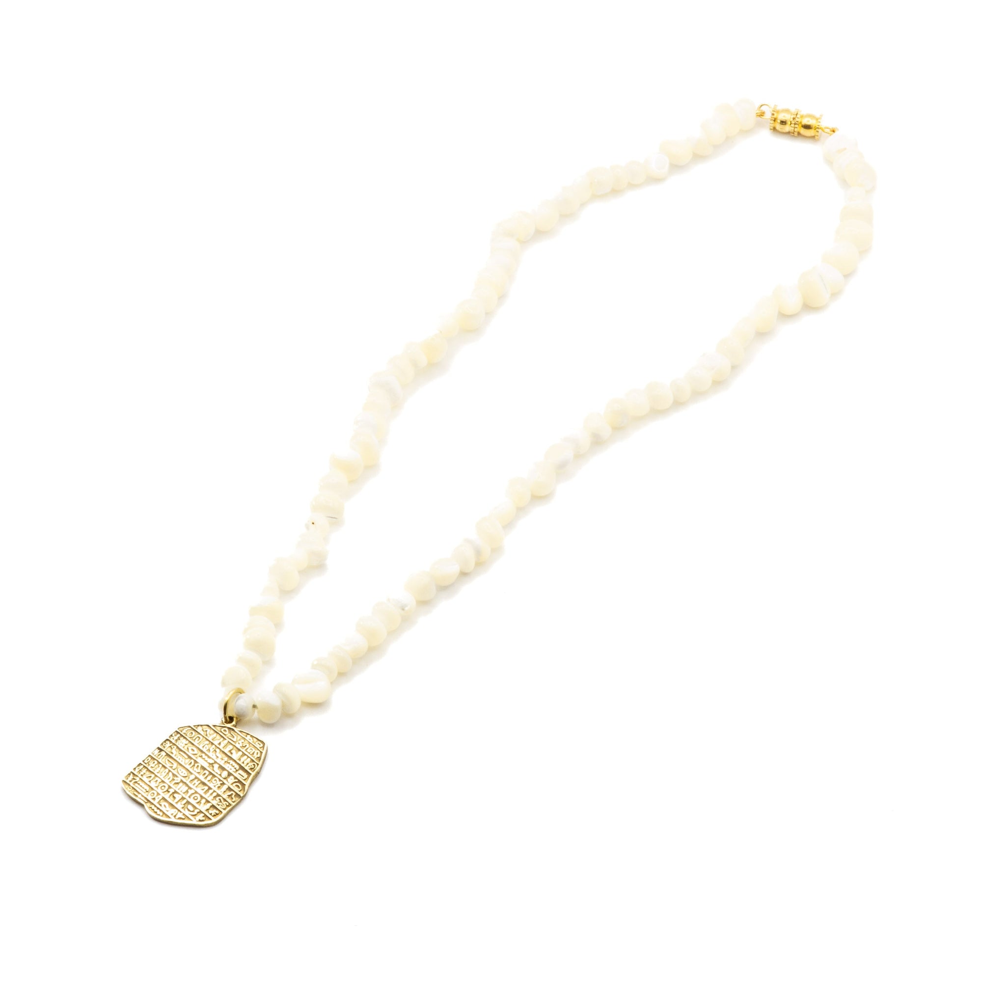 Full 35cm seashell chain necklace with raw brass charm, flat lay showing complete length