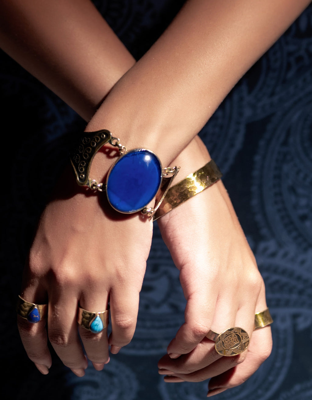Model wearing Fadela adjustable brass ring on hand, showing elegant fit and natural finish on finger