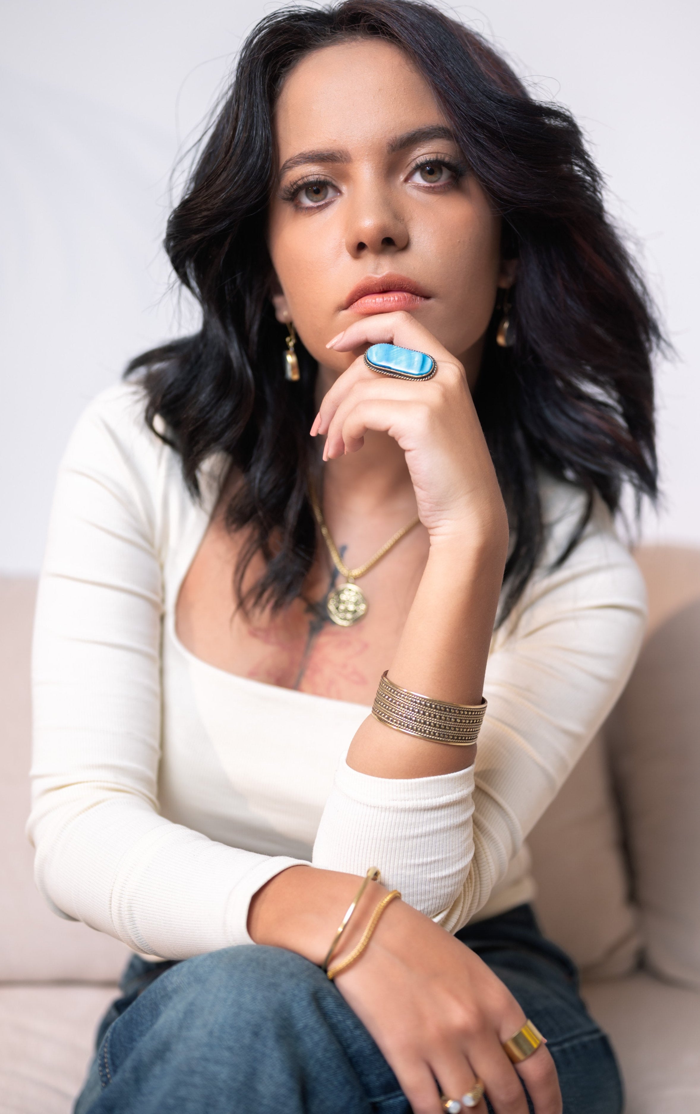 Side detail of Maysa brass necklace on model, highlighting hand-finished link texture and profile