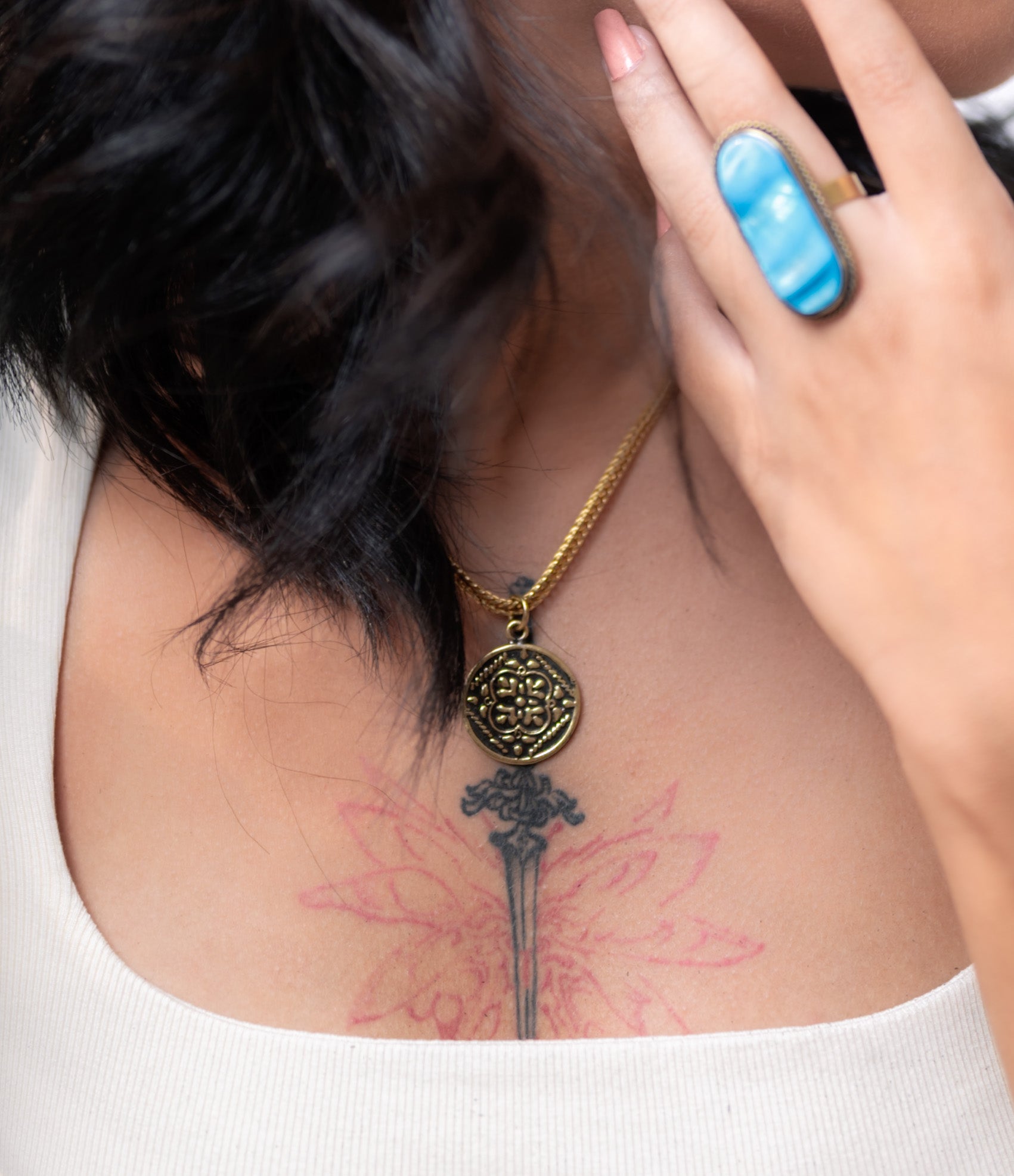 Front view of model wearing Maysa raw brass necklace, showing adjustable 40/45cm drape and natural finish