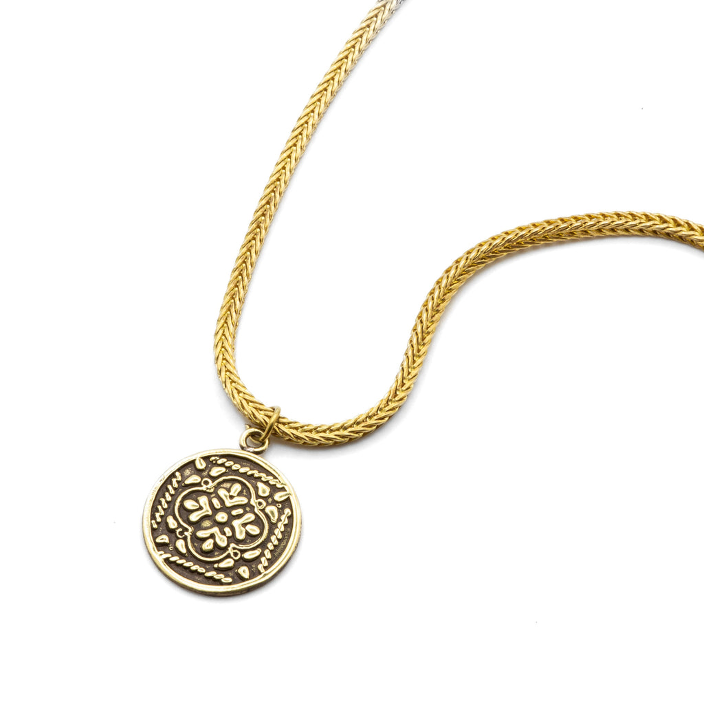 Flat lay detail of Maysa raw brass chain, showcasing inherited craftsmanship and natural patina
