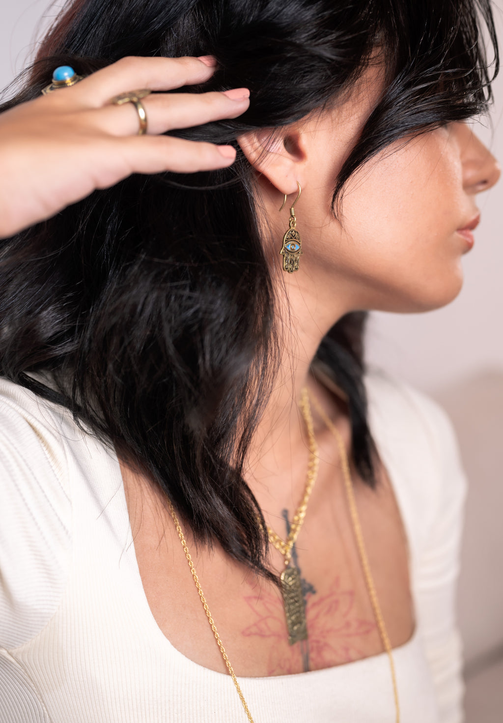 Side profile of Mona brass necklace, highlighting sculptural depth and contemporary edge