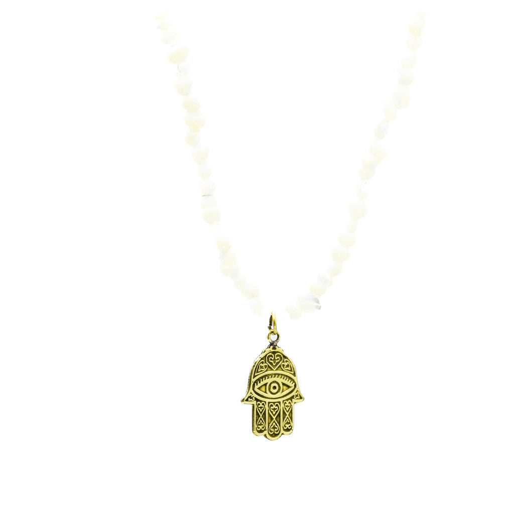 Close-up of raw Egyptian brass Nabila pendant, side neck view showing texture and antique finish