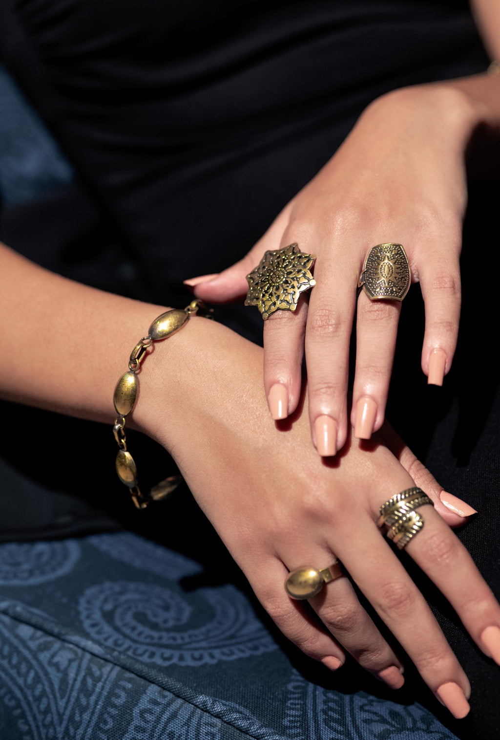 Model wearing Zahira adjustable brass cuff on wrist, showing 18cm fit and natural finish